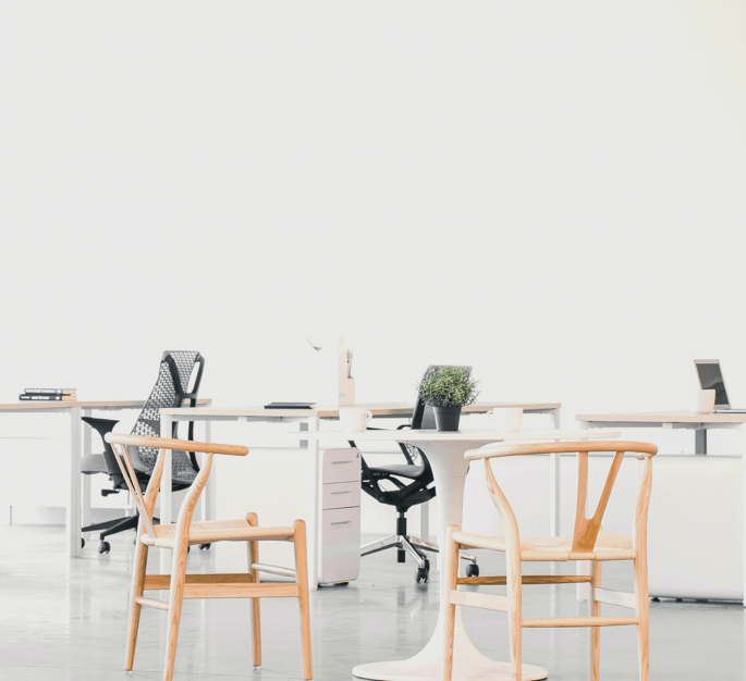 Un lugar de trabajo ordenado con una mesa y dos escritorios vacíos